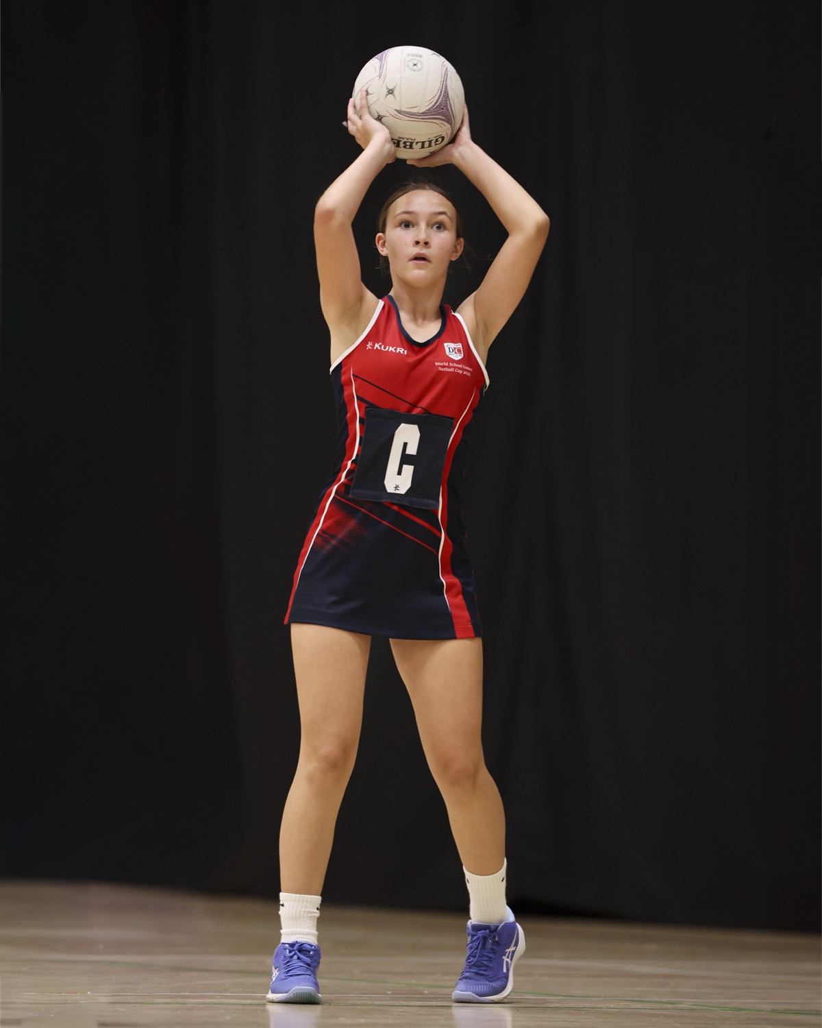A player holds the ball overhead, composed in possession